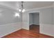 Charming dining room features wainscoting details, hardwood floors, and a decorative light fixture at 3357 Huntwood Ct, Decatur, GA 30034