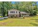 Charming two-story home boasts a welcoming front porch and a well-manicured lawn surrounded by mature trees at 3357 Huntwood Ct, Decatur, GA 30034