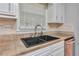 Close-up of kitchen sink, granite countertops, and tile backsplash at 3357 Huntwood Ct, Decatur, GA 30034