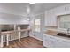 Bright eat-in kitchen features granite counters, white cabinets, modern hardware and wood-look flooring at 3357 Huntwood Ct, Decatur, GA 30034
