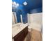 A blue bathroom with white shower and a vanity at 3429 Lake End Dr, Loganville, GA 30052