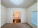 Cozy bedroom with neutral carpet, natural light, and an arched doorway at 3429 Lake End Dr, Loganville, GA 30052