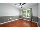 Charming bedroom featuring wood floors, a ceiling fan, and a large window with natural light at 5279 Leecroft Dr, Buford, GA 30518