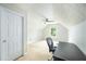 Upstairs bonus room featuring a neutral carpet, ceiling fan, and a bright window at 5279 Leecroft Dr, Buford, GA 30518