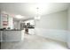Bright dining area featuring modern chandelier, kitchen access, and white wainscotting at 5279 Leecroft Dr, Buford, GA 30518