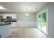 Bright dining area adjacent to the kitchen featuring modern lighting and a sliding door to the backyard at 5279 Leecroft Dr, Buford, GA 30518