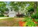 A charming home featuring a well-maintained lawn, an attached garage, and mature landscaping at 5279 Leecroft Dr, Buford, GA 30518