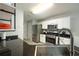Bright kitchen with stainless steel appliances, black countertops, and open shelving at 5279 Leecroft Dr, Buford, GA 30518