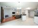 Open-concept kitchen and living room area with modern appliances, great lighting, and wood-burning fireplace at 5279 Leecroft Dr, Buford, GA 30518