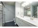 Elegant bathroom with double vanity, modern fixtures, a glass shower, and storage shelves at 5279 Leecroft Dr, Buford, GA 30518