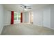 Spacious primary bedroom featuring a ceiling fan, neutral carpeting, and a bright window at 5279 Leecroft Dr, Buford, GA 30518