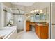 Bright bathroom featuring a soaking tub, glass shower, and granite countertops at 335 Scarborough Way, Alpharetta, GA 30022