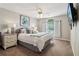 Comfortable bedroom with a queen-size bed, ceiling fan and a large window for plenty of natural light at 335 Scarborough Way, Alpharetta, GA 30022