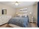Bright bedroom with a comfy queen bed, neutral walls, and stylish decor elements for a relaxing retreat at 335 Scarborough Way, Alpharetta, GA 30022
