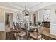 Elegant dining room featuring a glass-top table, ornate chairs, and modern lighting at 335 Scarborough Way, Alpharetta, GA 30022