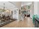 Elegant dining area with hardwood floors, chandelier, and views into the living room with fireplace at 335 Scarborough Way, Alpharetta, GA 30022