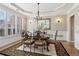 Formal dining room featuring shuttered windows, a decorative chandelier, and hardwood floors at 335 Scarborough Way, Alpharetta, GA 30022