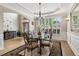 Bright dining space with hardwood floors, modern chandelier, and large windows with shutters at 335 Scarborough Way, Alpharetta, GA 30022