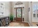 Elegant foyer featuring a decorative wood door with glass panels, hardwood floors, and neutral paint at 335 Scarborough Way, Alpharetta, GA 30022