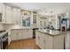 Open kitchen design with granite counters, white cabinets, stainless appliances, and eat in table at 335 Scarborough Way, Alpharetta, GA 30022