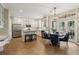 Bright kitchen with white cabinetry, stainless appliances, granite countertops, and hardwood flooring at 335 Scarborough Way, Alpharetta, GA 30022
