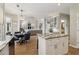 Spacious kitchen with stainless steel appliances, island and open floor plan to the living room at 335 Scarborough Way, Alpharetta, GA 30022