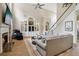 Bright living room with a fireplace, hardwood floors, and a staircase leading to the upper level at 335 Scarborough Way, Alpharetta, GA 30022