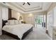 Spacious main bedroom with tray ceiling, plush carpet, and a seating area with large windows at 335 Scarborough Way, Alpharetta, GA 30022