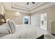 Bright main bedroom featuring a tray ceiling, neutral colors, and elegant furnishings at 335 Scarborough Way, Alpharetta, GA 30022