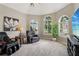 Bright sitting room featuring comfortable seating, a TV, and large arched windows at 335 Scarborough Way, Alpharetta, GA 30022