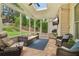 Relaxing sunroom with ample seating, a TV, and a view of the backyard at 335 Scarborough Way, Alpharetta, GA 30022