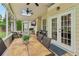 Inviting sunroom with an outdoor dining area and a comfortable seating area for relaxation and entertainment at 335 Scarborough Way, Alpharetta, GA 30022