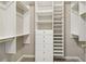 Custom walk-in closet with ample shelving, drawers, and storage at 335 Scarborough Way, Alpharetta, GA 30022