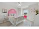 Bright bedroom featuring a pink headboard, neutral carpet, and a window with natural light at 4090 Sierra Knolls Ct, Cumming, GA 30040