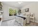 Serene bedroom with a large window offering views of the landscaped backyard at 4090 Sierra Knolls Ct, Cumming, GA 30040