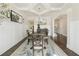 Elegant dining room with coffered ceiling, wainscoting, and stylish decor at 4090 Sierra Knolls Ct, Cumming, GA 30040