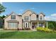 Charming two-story brick home with a well-manicured lawn and colorful landscaping at 4090 Sierra Knolls Ct, Cumming, GA 30040