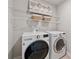 Laundry room with modern washer and dryer and wire shelving at 4090 Sierra Knolls Ct, Cumming, GA 30040