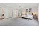 Airy main bedroom boasts plush carpet, ample space, and tranquil decor at 4090 Sierra Knolls Ct, Cumming, GA 30040