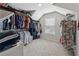 A walk-in closet featuring built-in shelving and neutral carpet at 4090 Sierra Knolls Ct, Cumming, GA 30040