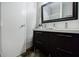 This bathroom features a spacious vanity with storage and a decorative mirror at 5200 Peachtree Rd # 1104, Atlanta, GA 30341