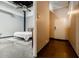 Bedroom features industrial polished concrete floors and an adjacent hallway and door at 5200 Peachtree Rd # 1104, Atlanta, GA 30341