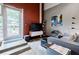 Stylish living room with concrete steps to patio and brick accent wall at 5200 Peachtree Rd # 1104, Atlanta, GA 30341