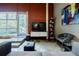 Living room with grey sofa, brick accent wall and views to the outside at 5200 Peachtree Rd # 1104, Atlanta, GA 30341