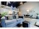 Comfortable living room with a cozy sofa, open to the dining area and modern kitchen, featuring industrial ceilings at 5200 Peachtree Rd # 1104, Atlanta, GA 30341
