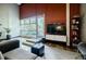 Comfortable living room with brick accent wall and outdoor views at 5200 Peachtree Rd # 1104, Atlanta, GA 30341