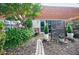 Charming outdoor patio with stone pathway, lush plants, and privacy screen, a perfect retreat for relaxation at 5200 Peachtree Rd # 1104, Atlanta, GA 30341