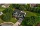 Aerial view of the home nestled among mature trees, showcasing its landscaped yard and serene setting at 15 Saddlebrook Ct, Covington, GA 30016