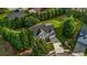 Top-down aerial view of home with landscaped yard featuring a stone patio and mature shade trees at 15 Saddlebrook Ct, Covington, GA 30016