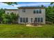 Rear exterior featuring a patio area with outdoor seating and a lush lawn at 15 Saddlebrook Ct, Covington, GA 30016